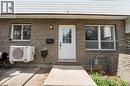 Brick facade with white siding accents and a white entry door - 391 Pioneer Drive Unit# 4, Kitchener, ON  - Outdoor With Exterior 
