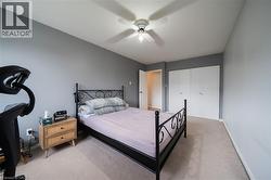 Carpeted room with a ceiling fan light fixture - 
