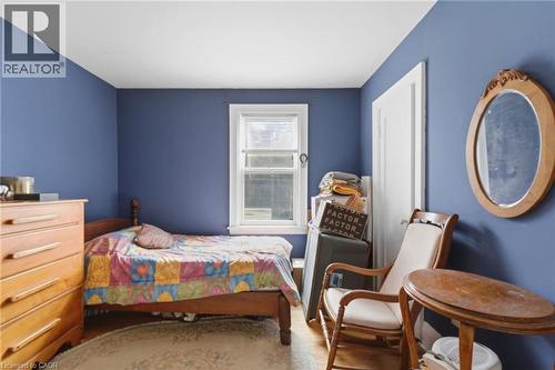 Room with blue painted walls, a single window, and a white interior door - 509 Aberdeen Avenue, Hamilton, ON - Indoor Photo Showing Bedroom