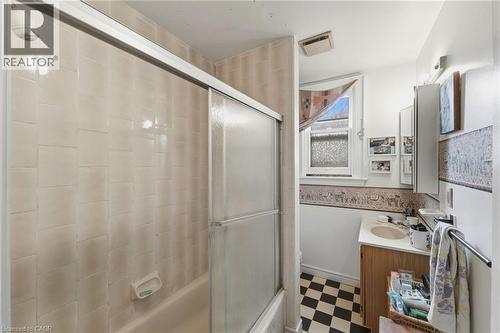 Bathroom featuring a tiled shower with sliding glass doors, a vanity with a built-in sink, a wall-mounted medicine cabinet, and checkerboard floor tiles - 509 Aberdeen Avenue, Hamilton, ON - Indoor Photo Showing Other Room