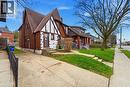 Tudor-style semi-detached residence featuring brick and white stucco exterior with dark trim accents - 509 Aberdeen Avenue, Hamilton, ON  - Outdoor 
