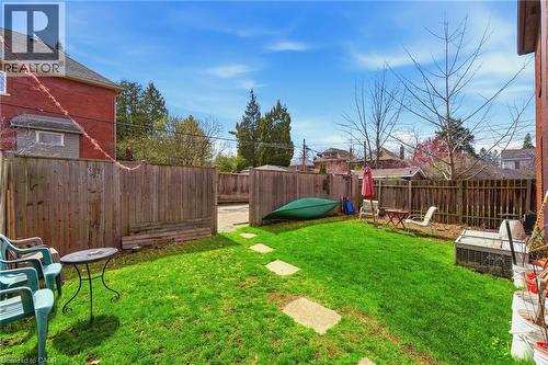 Private rear yard with a manicured lawn, stone stepping path, and wood fencing - 509 Aberdeen Avenue, Hamilton, ON - Outdoor
