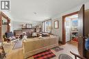Living space featuring wood-finish flooring, a brick fireplace, white trim, wood door frames, and multi-pane windows - 509 Aberdeen Avenue, Hamilton, ON  - Indoor With Fireplace 