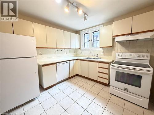 Kitchen featuring white cabinetry, a white electric range, a white dishwasher, and a white refrigerator - 509 Aberdeen Avenue, Hamilton, ON - Indoor Photo Showing Kitchen With Double Sink