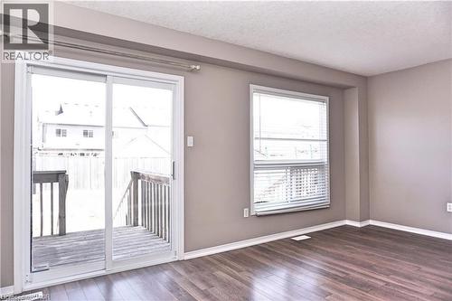 Interior space featuring wood-finish flooring, neutral wall tones, and white baseboards - 40 Madeleine Street, Kitchener, ON 