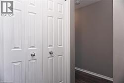 White bi-fold closet doors with panel detailing and brushed nickel hardware - 