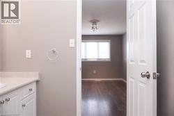 Bathroom vanity with light-colored countertop and white cabinetry - 