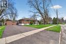 Brick-clad residence featuring a paved driveway, front lawn, and mature trees - 53 Nicklin Crescent, Guelph, ON  - Outdoor 