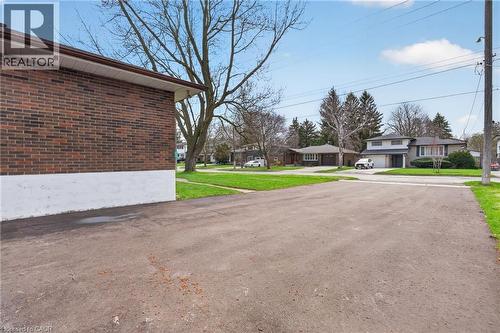 Expansive asphalt driveway with a brick and white facade - 53 Nicklin Crescent, Guelph, ON - Outdoor