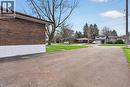Expansive asphalt driveway with a brick and white facade - 53 Nicklin Crescent, Guelph, ON  - Outdoor 