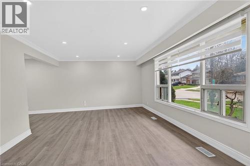 Spacious room with wood-finish flooring, recessed lighting, and crown molding - 53 Nicklin Crescent, Guelph, ON - Indoor Photo Showing Other Room