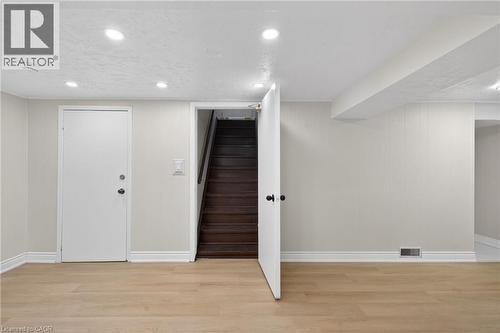 Spacious room featuring wood-finish flooring, recessed lighting, and crisp white trim - 53 Nicklin Crescent, Guelph, ON - Indoor