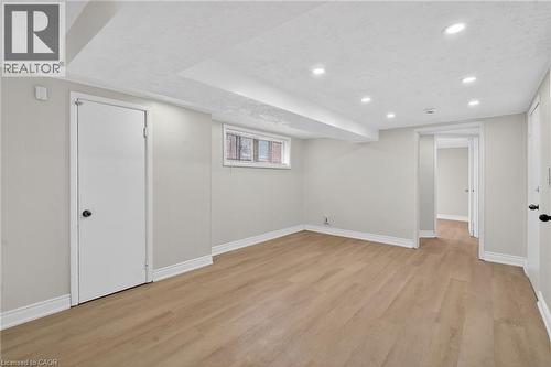 Open room featuring wood-finish flooring, recessed lighting, and a neutral color palette - 53 Nicklin Crescent, Guelph, ON - Indoor