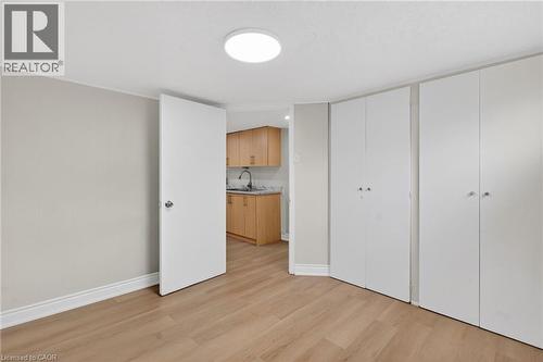 Light wood-finish flooring extending into the kitchen area - 53 Nicklin Crescent, Guelph, ON - Indoor