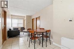 Open-concept living area with tiled flooring - 