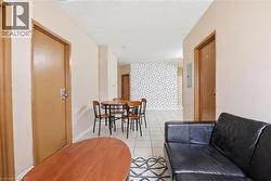 Central common area featuring light-toned walls and a white tiled floor - 