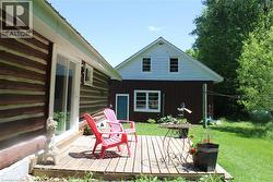 Wood deck with a sliding glass door entry to the log-sided structure - 