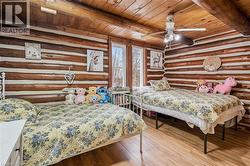 Interior room featuring log walls and a wood-plank ceiling - 