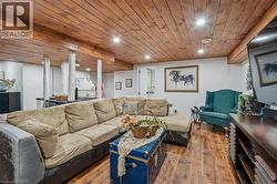Wood-finish flooring throughout, featuring a wood-plank ceiling with recessed lighting - 