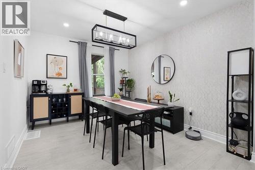 Spacious room featuring light wood-finish flooring, recessed lighting, and a modern rectangular chandelier - 133 Frederick Avenue, Hamilton, ON - Indoor Photo Showing Dining Room