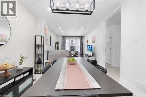 Open-concept dining area featuring a modern black chandelier, recessed lighting, and light-toned flooring - 133 Frederick Avenue, Hamilton, ON - Indoor Photo Showing Other Room