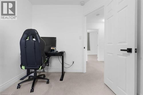 Neutral carpet flooring and white painted walls define this interior space - 133 Frederick Avenue, Hamilton, ON - Indoor