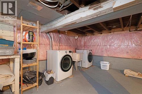 Basement laundry area with concrete flooring and exposed ceiling joists - 133 Frederick Avenue, Hamilton, ON - Indoor Photo Showing Laundry Room