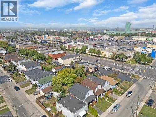 Residential neighborhood with mature trees, established roadways, commercial buildings, and surface parking lots under a clear sky - 133 Frederick Avenue, Hamilton, ON - Outdoor With View