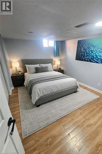 Bedroom featuring light wood-finish flooring, white baseboards, and light blue wall paint - 34 Christopher Drive, Cambridge, ON - Indoor Photo Showing Bedroom