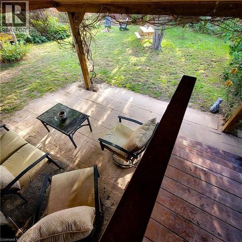 Spacious outdoor deck with wood flooring and a covered patio area - 34 Christopher Drive, Cambridge, ON - Outdoor