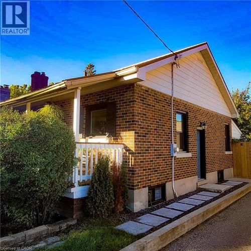 Brick exterior with white siding accents and a pitched roofline - 34 Christopher Drive, Cambridge, ON - Outdoor With Exterior
