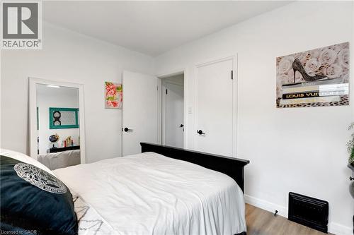 Interior room featuring wood-finish flooring, white walls, and white trim - 34 Christopher Drive, Cambridge, ON - Indoor Photo Showing Bedroom
