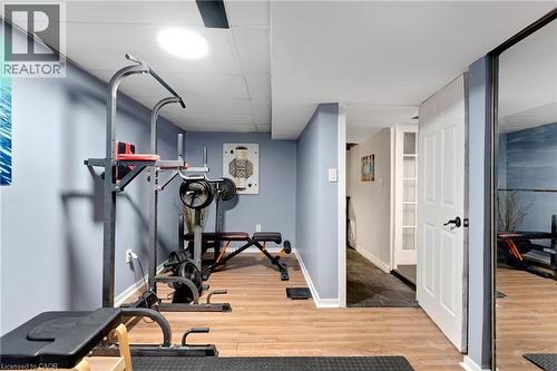 Recreation area featuring wood-finish flooring, light blue walls, and a recessed ceiling light - 34 Christopher Drive, Cambridge, ON - Indoor Photo Showing Gym Room