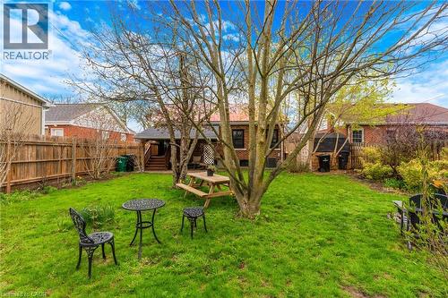 Expansive backyard featuring a lush lawn, mature trees, and privacy fencing - 34 Christopher Drive, Cambridge, ON - Outdoor