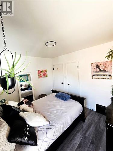 Bedroom featuring wood-finish flooring, white walls, and a flush-mount ceiling light - 34 Christopher Drive, Cambridge, ON - Indoor Photo Showing Bedroom