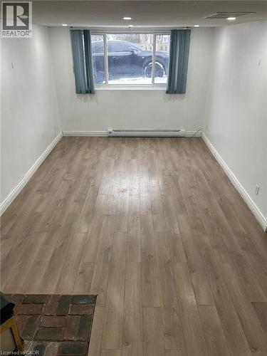 Open room featuring wood-finish flooring, white walls, and recessed lighting - 744 Parkview Crescent, Cambridge, ON - Indoor Photo Showing Other Room