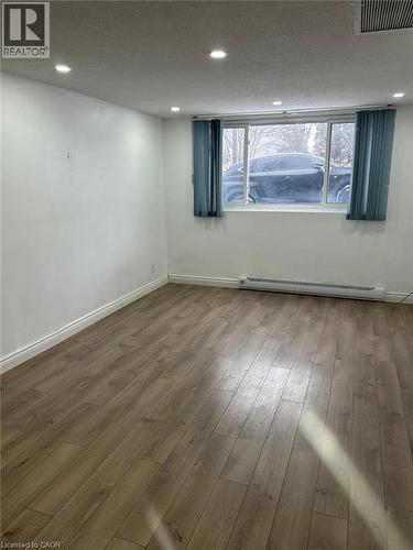 Room featuring wood-finish flooring, white baseboards, and neutral wall tones - 744 Parkview Crescent, Cambridge, ON - Indoor Photo Showing Other Room