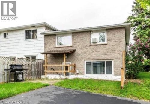 Brick exterior featuring a covered porch with wood railings - 744 Parkview Crescent, Cambridge, ON - Outdoor