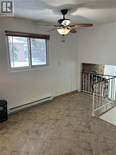 Spacious room featuring neutral-toned tile flooring and white painted walls - 744 Parkview Crescent, Cambridge, ON - Indoor Photo Showing Other Room