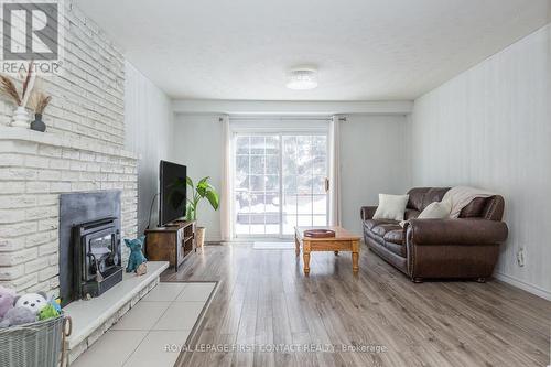 Patio doors lead directly to the backyard. - 3 Oren Boulevard, Barrie, ON - Indoor Photo Showing Living Room With Fireplace