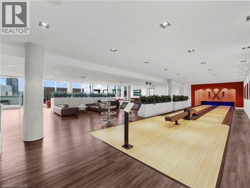 Bowling alley with wood-finish flooring, recessed lighting, expansive windows, and a vibrant red accent wall - 5 Wellington Street S Unit# 904, Kitchener, ON - Indoor