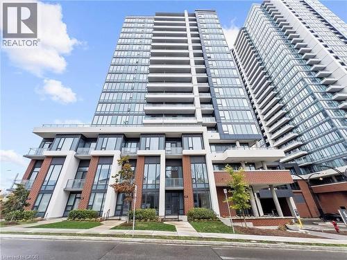 Modern high-rise residential building featuring a glass facade and multiple balconies - 5 Wellington Street S Unit# 904, Kitchener, ON - Outdoor With Facade
