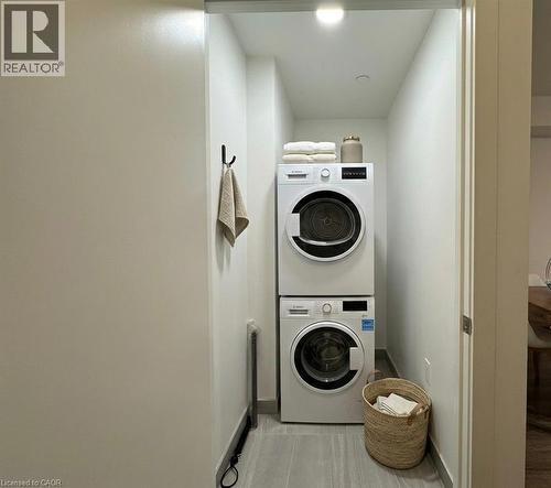 Dedicated laundry closet featuring a stacked washer and dryer, recessed lighting, and tile flooring - 5 Wellington Street S Unit# 904, Kitchener, ON - Indoor Photo Showing Laundry Room