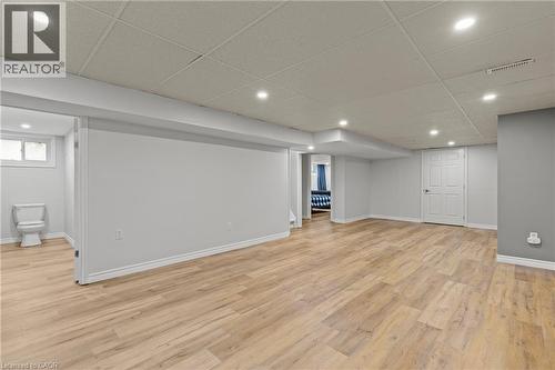 Expansive finished lower level featuring wood-finish flooring, recessed lighting, drop ceiling, and light gray walls - 45 Driftwood Drive, Brantford, ON - Indoor