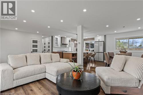 Open-concept living space featuring wood-finish flooring, recessed lighting, and white walls - 45 Driftwood Drive, Brantford, ON - Indoor Photo Showing Living Room