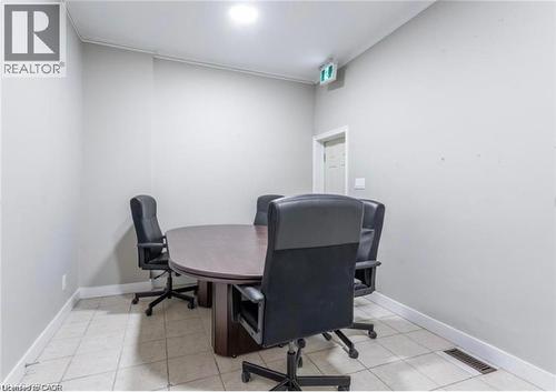 Office space featuring light-colored walls and tiled flooring - 833 King Street E, Hamilton, ON 