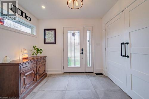 Entryway featuring a double door with glass inserts, transom window, and large format tile flooring - 1486 Augustine Drive, Burlington, ON - Indoor Photo Showing Other Room