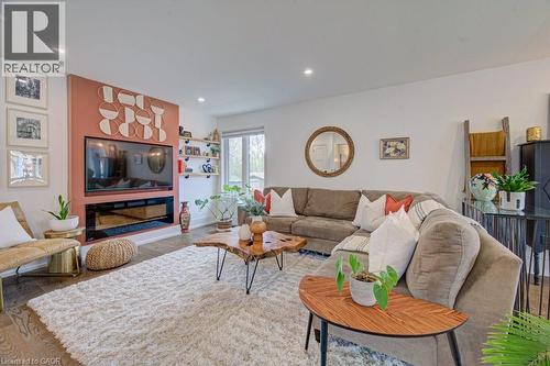Spacious living area featuring a built-in electric fireplace and media wall - 1486 Augustine Drive, Burlington, ON - Indoor Photo Showing Living Room