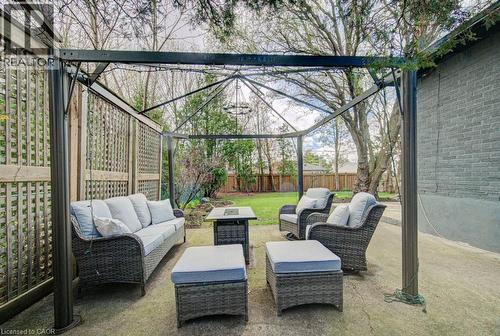Patio area featuring a dark metal gazebo structure and a concrete surface - 1486 Augustine Drive, Burlington, ON - Outdoor