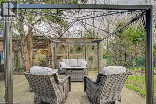 Outdoor patio area featuring a metal gazebo structure and concrete flooring - 1486 Augustine Drive, Burlington, ON - Outdoor